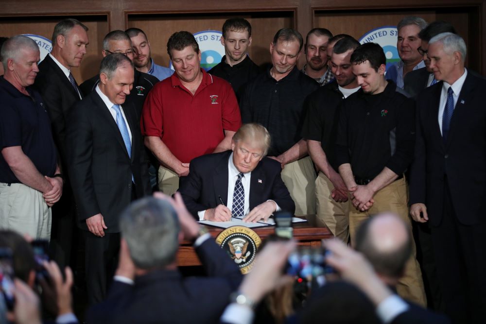 Then-U.S. President Donald Trump signs an executive order titled "Energy Independence" during a March 28, 2017, event. Then-U.S. President Donald Trump signs an executive order titled "Energy Independence" during a March 28, 2017, event.